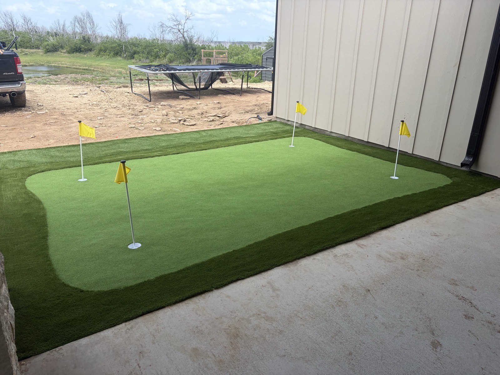 Strip of artificial turf running alongside a pool deck