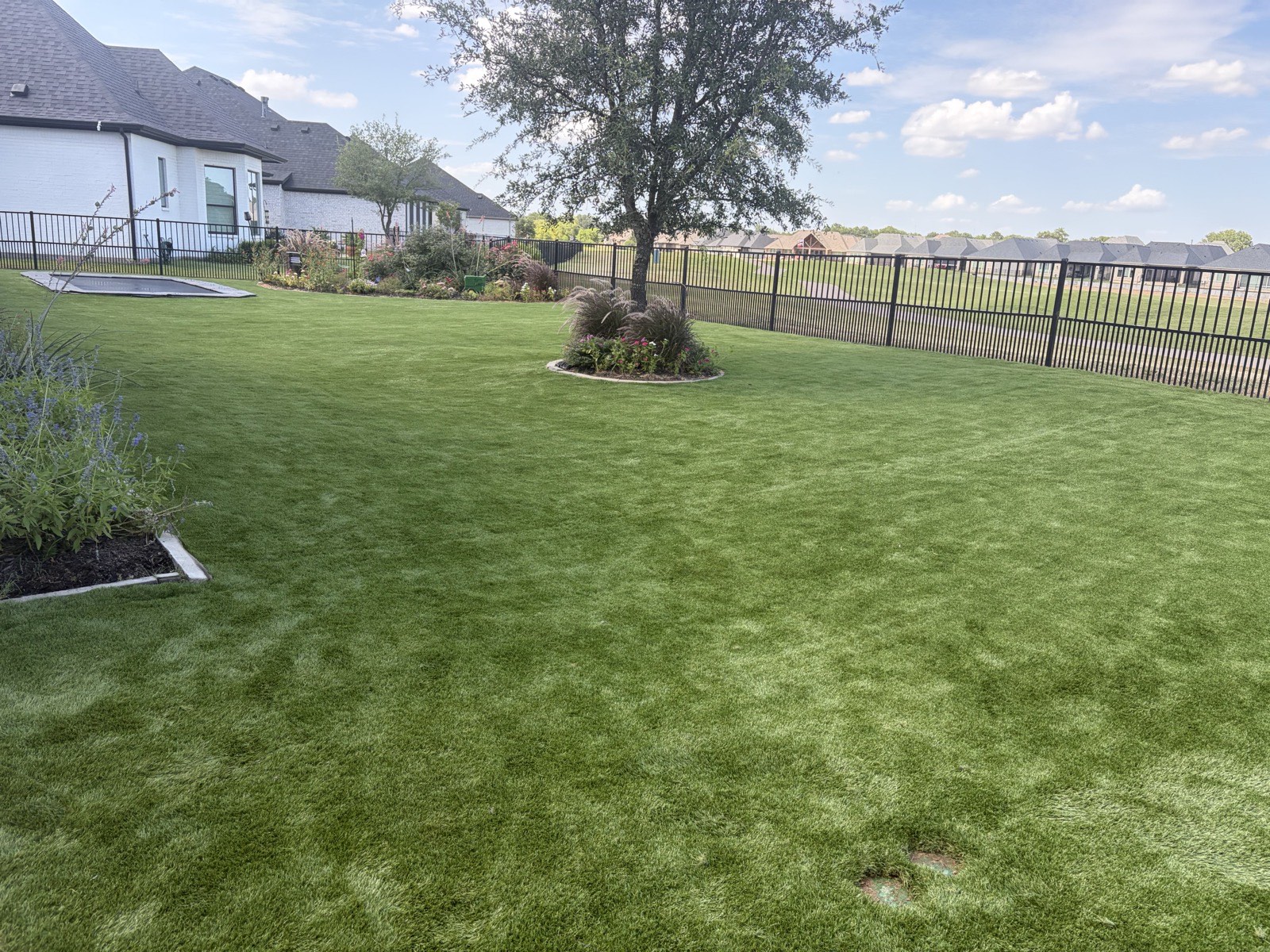 Artificial putting green installed beside a metal building